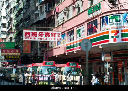 Busy street with public light buses and advertising signs, Mong Kok, Kowloon, Hong Kong, China Stock Photo