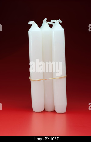 A bunch of candles tied with an elastic band Stock Photo