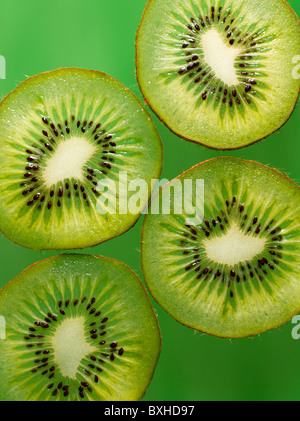 kiwi fruit slices on green background Stock Photo