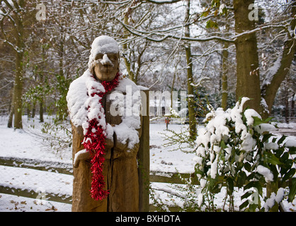 A wooden sculpture covered in snow in Thorndon Park in Essex.  Photograph by Gordon Scammell Stock Photo