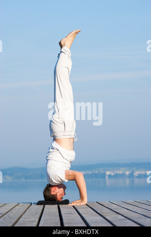 Man doing a headstand Stock Photo