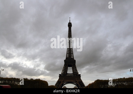 The Eiffel Tower under cloudy skies during sunset. Stock Photo