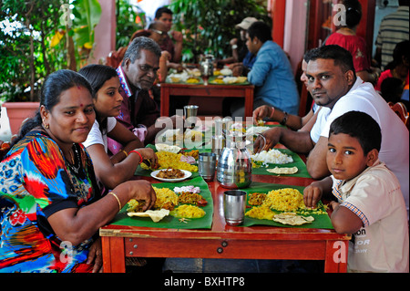 Indian Family eating meal together in Little India Singapore Stock Photo