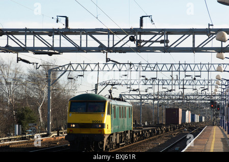 Freight train travelling through Colchester railway station UK Stock Photo