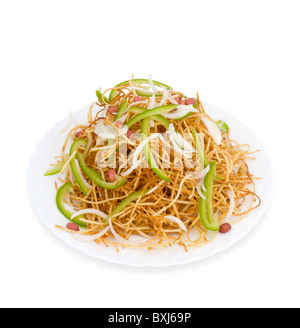 Chinese food. Salad of potatoe chips, peanuts, paprika and onion, isolated on white. Stock Photo