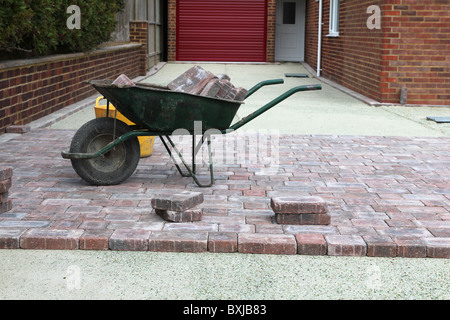 Concrete block paving bricks being laid on a driveway of a house. Stock Photo