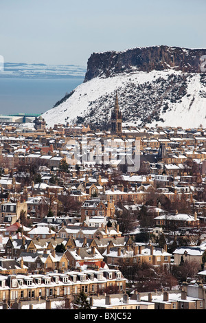 Salisbury Crags in Holyrood Park, viewed over Sciennes from Blackford Hill, Edinburgh, Scotland, UK. Stock Photo