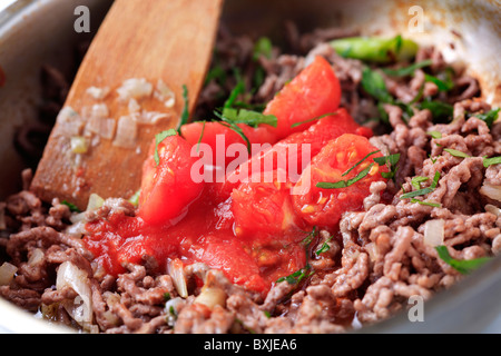 Preparing ragu alla Bolognese in a pan Stock Photo