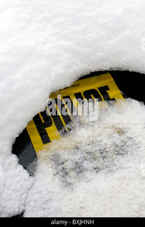 Police warning sign on  snow covered car windscreen. Stock Photo
