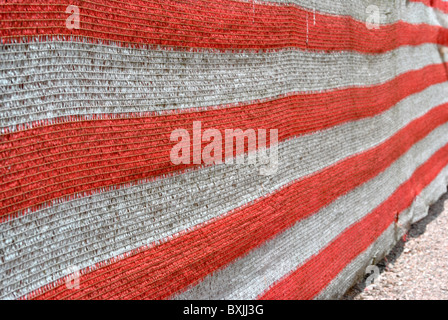 drop cloth red and white nylon used on construction sites Stock Photo