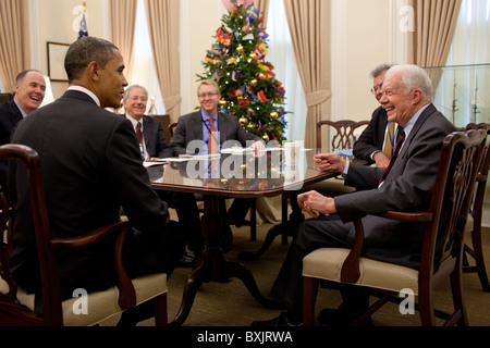 President Barack Obama talks with former President Jimmy Carter