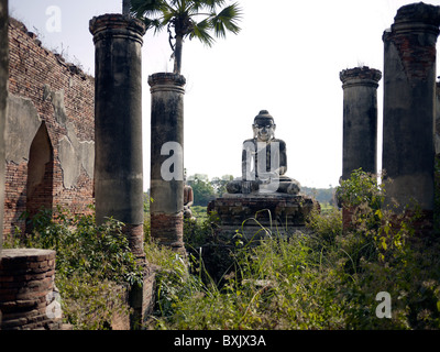 Buddha statue in a ruined temple on the island of Inwa, near Mandalay, Burma, Myanmar Stock Photo