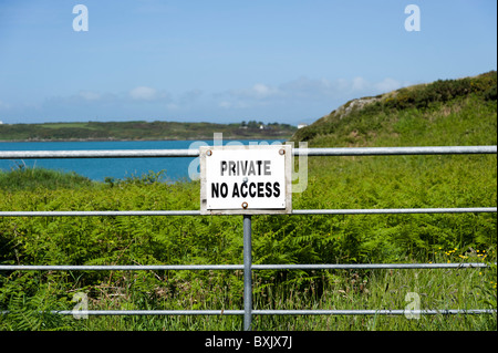 Private No Access sign across barrier on coastal land on Sherkin Island, County Cork, Ireland Stock Photo