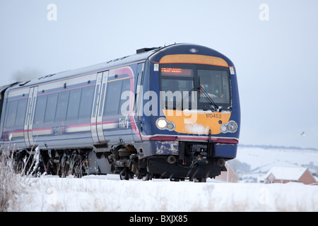 Local commuter train service running in winter scenery Montrose east coast Scotland. Stock Photo