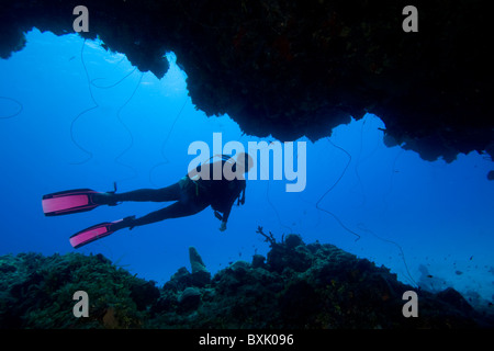 Female Scuba diver exploring Cave Rock, Eleuthera, Bahama Islands Stock Photo