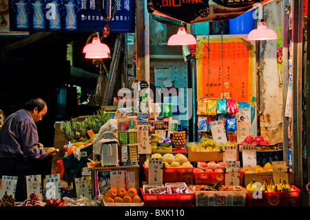 Oriental customers in front of fruit and vegetable market in downtown Hong Kong China Stock Photo