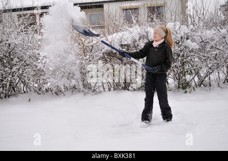 Yong girl shoveling snow. Stock Photo