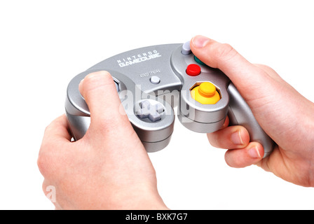 Teen hands playing with Nintendo game cube handset controller Stock Photo