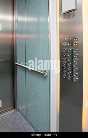 contemporary elevator interior with control panel and steel doors Stock Photo