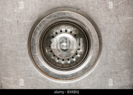 Stainless steel sink plug in a sink with water Stock Photo