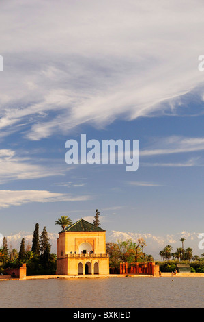 Basin and menzah, View across pool to pavilion at Menara Gardens snow capped High Atlas Mountains Stock Photo