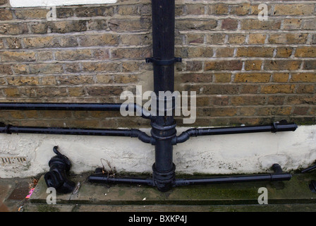 Cast Iron drainpipes and guttering on a Victorian building London UK Stock Photo