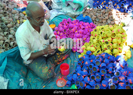 Artisan painting earthen pots. These pots are used in Diwali Stock Photo