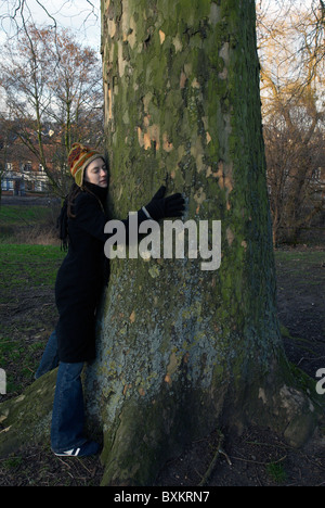 Woman hugging a tree Stock Photo