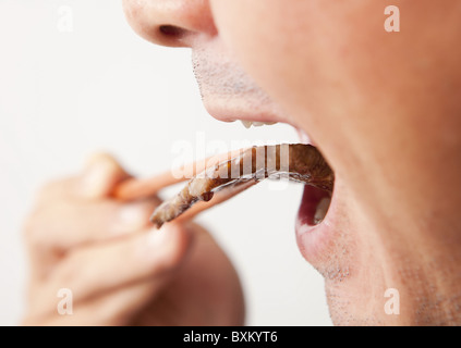 A man eating korean barbecue Stock Photo