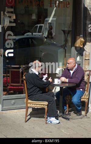 Israel, Tel Aviv. Men at sidewalk cafe. Stock Photo