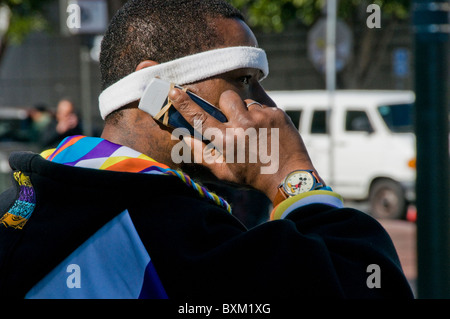 Athletic black man talking on cell phone in urban environment Stock Photo