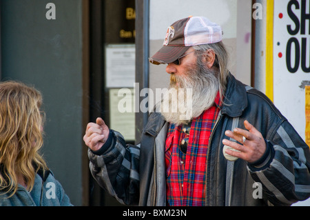 Homeless man and woman talking on city street in San Francisco CA USA California Stock Photo