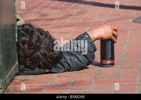 Homeless drunk man sleeping on city street in San Francisco CA USA California Stock Photo