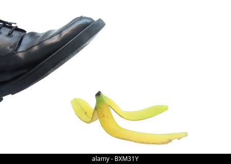 Business boot to step on a banana skin on a white Stock Photo