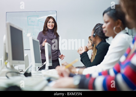multiethnic group of female customer service representatives in a meeting, adult businesswoman talking. Stock Photo
