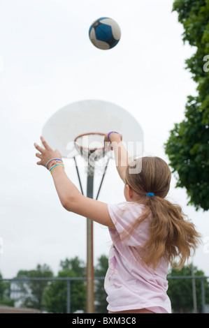 Elementary school boys and girls play basketball with fellow students at the Beech Elementary school in Manchester NH Stock Photo