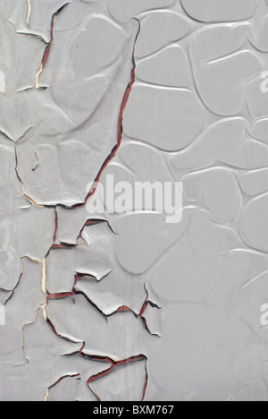 cracked bubbling grey plastic film on a glass window Stock Photo