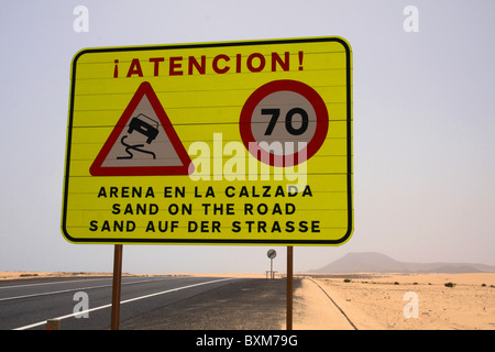 Desert driving conditions, warning sign of sand on road. Very dangerous driving conditions when maneuvering,i.e. overtaking. Stock Photo