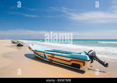 Small fishing boat available for hire photographed at dawn in West Bay  Roatan Honduras Stock Photo - Alamy