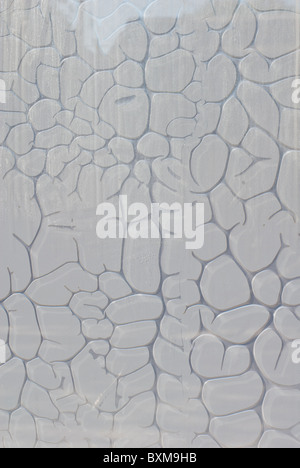 bubbling grey plastic film on a glass surface Stock Photo