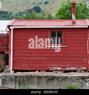 A red painted shed at the disused Little River Station, Banks Peninsular, New Zealand Stock Photo