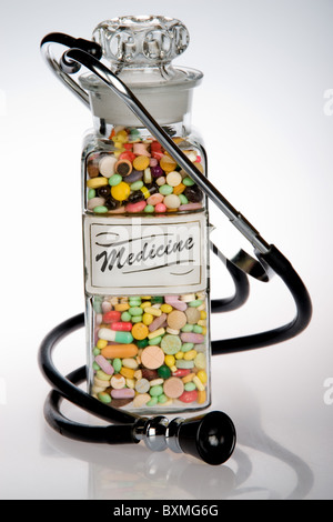 Retro medical concept featuring antique pill bottle and old stethoscope Stock Photo