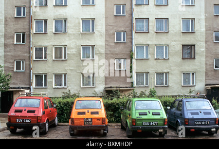 Colourful Eastern bloc Polski Fiat 126 cars in front of flats, Poland Stock Photo
