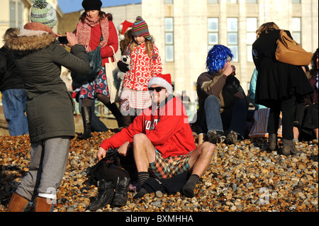 Hundreds of people gather on Brighton Beach to watch and take part in the annual Christmas Day swim Stock Photo