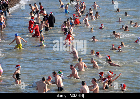 Hundreds of people gather on Brighton Beach to watch and take part in the annual Christmas Day swim Stock Photo