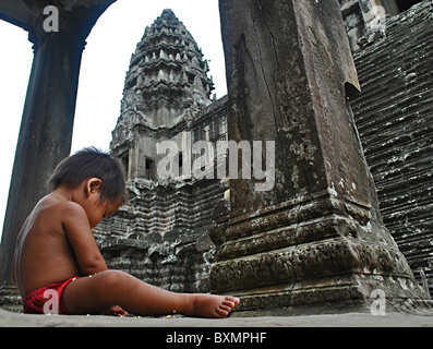 Baby sitting in Angkor Wat temple, Siem Reap, Cambodia Stock Photo