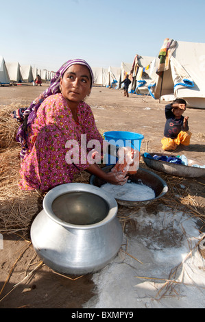 Pakistan. Sindh province. After the flood.Railway camp. Woman washing clothes. Stock Photo