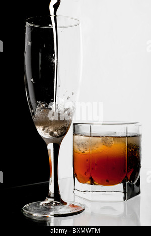 Glass of champagne and whisky with ice. A black and white background. Stock Photo