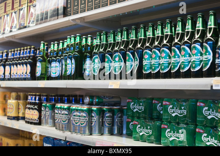Glass bottles and of aluminum beer cans on shop shelves Stock Photo
