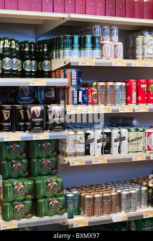 Glass bottles and of aluminum beer cans on shop shelves Stock Photo